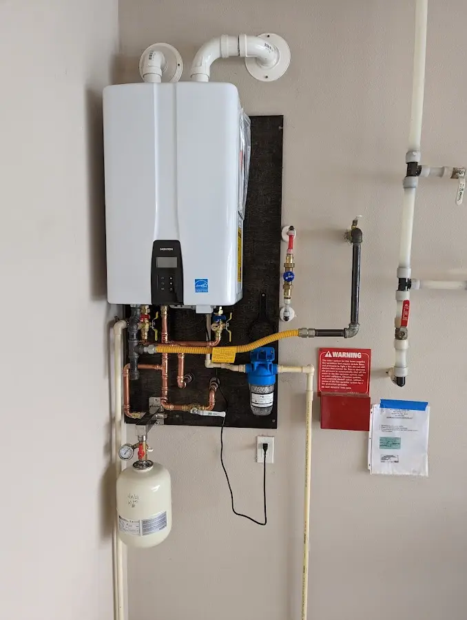 Professional plumber installing copper piping in a Eagle Crest home